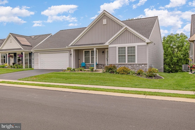 2069 Spring Wood Ln, Mechanicsburg, PA 17055 - view of front facade with board and batten siding, a front lawn, a garage, covered porch, and driveway