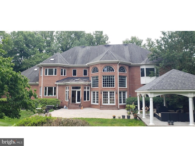 8902 Chequers Way, Mclean, VA 22102 - rear view of house with a gazebo, entry steps, a patio area, brick siding, and an outdoor living space