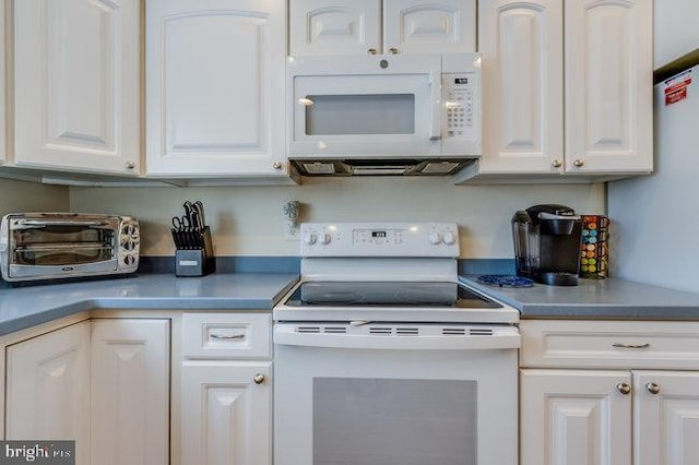 9707 Village Ln Unit 9704-4, Ocean City, MD 21842 - kitchen featuring white appliances and white cabinetry