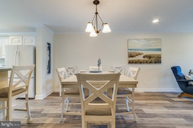 9707 Village Ln Unit 9704-4, Ocean City, MD 21842 - dining space with a chandelier, crown molding, light wood-type flooring, and recessed lighting