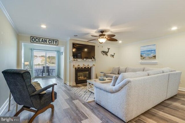 9707 Village Ln Unit 9704-4, Ocean City, MD 21842 - living room featuring ornamental molding, ceiling fan, a glass covered fireplace, recessed lighting, and wood finished floors