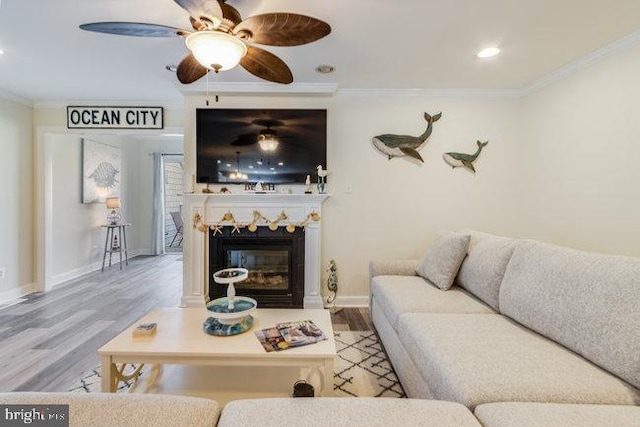 9707 Village Ln Unit 9704-4, Ocean City, MD 21842 - living area featuring crown molding, wood finished floors, ceiling fan, recessed lighting, and a glass covered fireplace