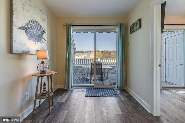 9707 Village Ln Unit 9704-4, Ocean City, MD 21842 - doorway featuring wood finished floors and baseboards