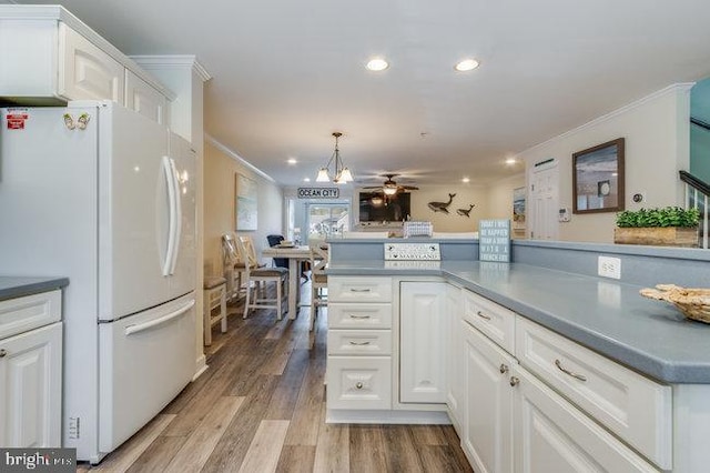 9707 Village Ln Unit 9704-4, Ocean City, MD 21842 - kitchen featuring freestanding refrigerator, ornamental molding, white cabinets, wood finished floors, and recessed lighting