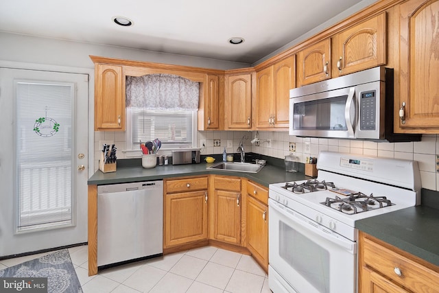 122 Randolph Ave, South Plainfield, NJ 07080 - kitchen featuring appliances with stainless steel finishes, dark countertops, tasteful backsplash, and light tile patterned floors