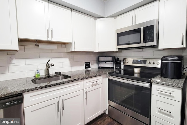 5200 Hilltop Dr Unit A2, Brookhaven, PA 19015 - kitchen with appliances with stainless steel finishes, white cabinets, backsplash, and dark stone countertops