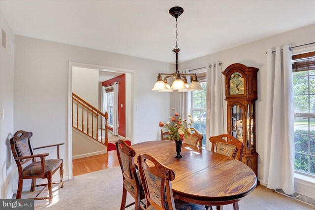 64 S 3rd St, New Freedom, PA 17349 - dining area featuring a chandelier, stairway, and light colored carpet