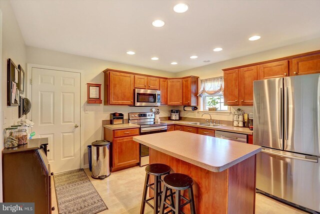 64 S 3rd St, New Freedom, PA 17349 - kitchen with stainless steel appliances, recessed lighting, a kitchen island, a breakfast bar, and light countertops