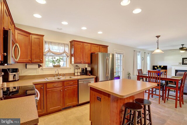 64 S 3rd St, New Freedom, PA 17349 - kitchen featuring appliances with stainless steel finishes, a center island, a ceiling fan, light countertops, and a kitchen bar