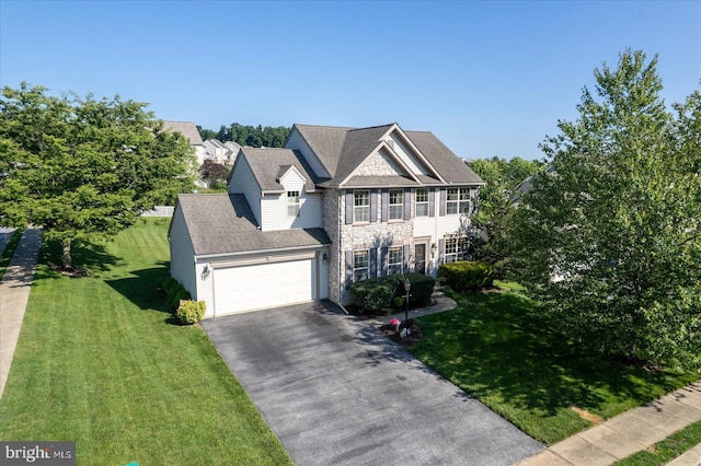 64 S 3rd St, New Freedom, PA 17349 - view of front facade featuring asphalt driveway, a garage, stone siding, and a front yard