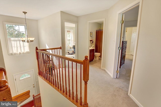 64 S 3rd St, New Freedom, PA 17349 - hall featuring a chandelier, an upstairs landing, and light colored carpet