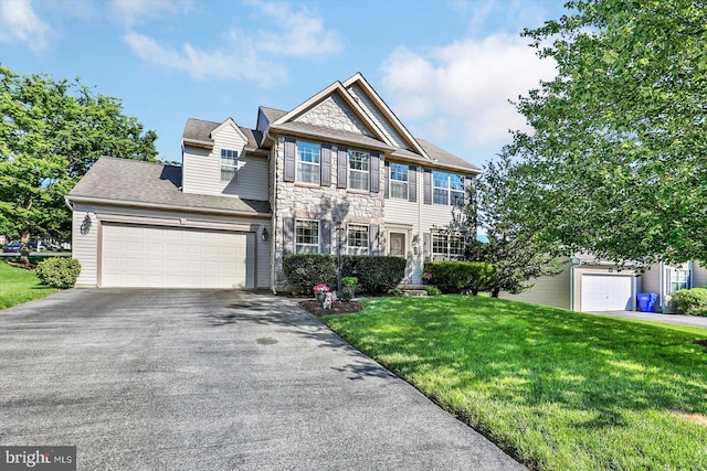 64 S 3rd St, New Freedom, PA 17349 - view of front facade with stone siding, driveway, a front yard, and a garage
