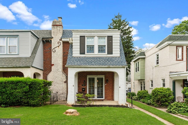 613 Arbor Rd, Cheltenham, PA 19012 - view of front of house with a chimney, a shingled roof, french doors, and a front yard
