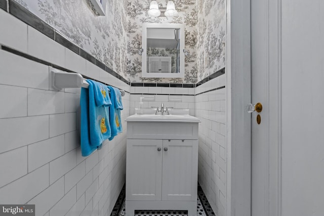 613 Arbor Rd, Cheltenham, PA 19012 - half bathroom with tile walls, wallpapered walls, vanity, and a wainscoted wall