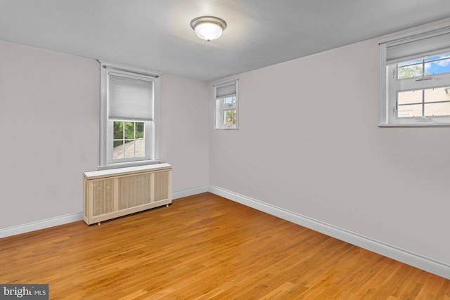 613 Arbor Rd, Cheltenham, PA 19012 - empty room with radiator heating unit and light wood-style floors