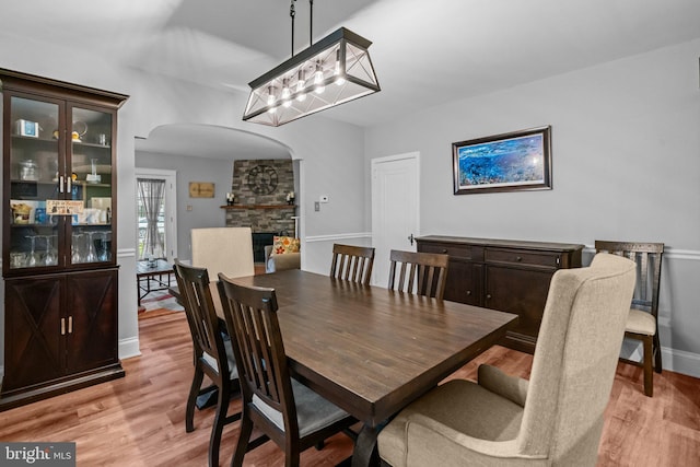 613 Arbor Rd, Cheltenham, PA 19012 - dining area featuring arched walkways, light wood-style floors, and a chandelier