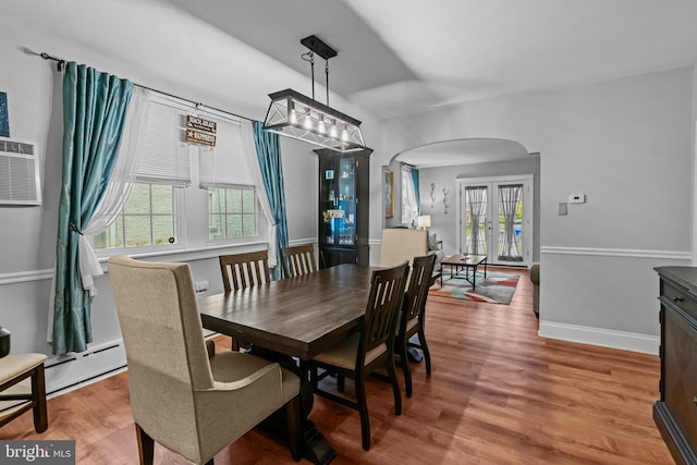 613 Arbor Rd, Cheltenham, PA 19012 - dining space with arched walkways, french doors, and wood finished floors