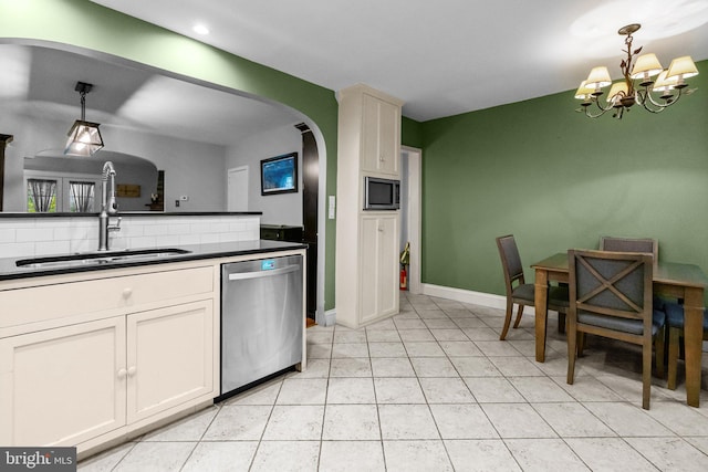 613 Arbor Rd, Cheltenham, PA 19012 - kitchen with stainless steel appliances, arched walkways, dark countertops, a chandelier, and recessed lighting