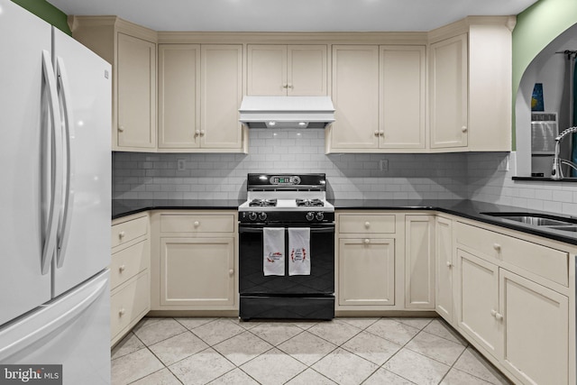 613 Arbor Rd, Cheltenham, PA 19012 - kitchen featuring freestanding refrigerator, gas stove, custom exhaust hood, cream cabinetry, and decorative backsplash