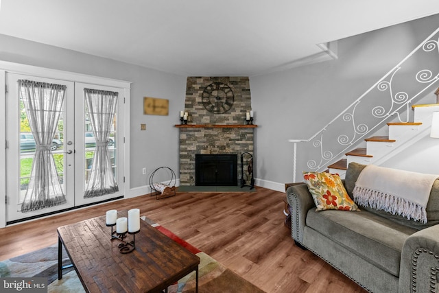 613 Arbor Rd, Cheltenham, PA 19012 - living room with french doors, stairs, wood finished floors, and a stone fireplace