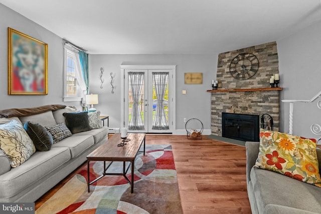 613 Arbor Rd, Cheltenham, PA 19012 - living area with wood finished floors, healthy amount of natural light, french doors, and a fireplace