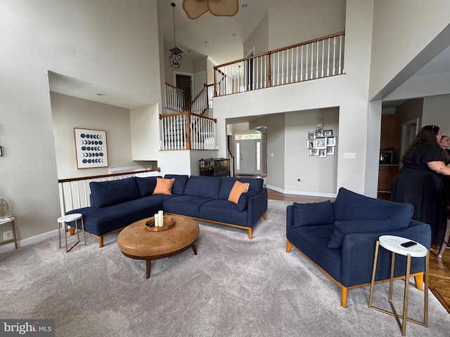 8710 Brenton Dr, Easton, MD 21601 - carpeted living room with stairs and a towering ceiling