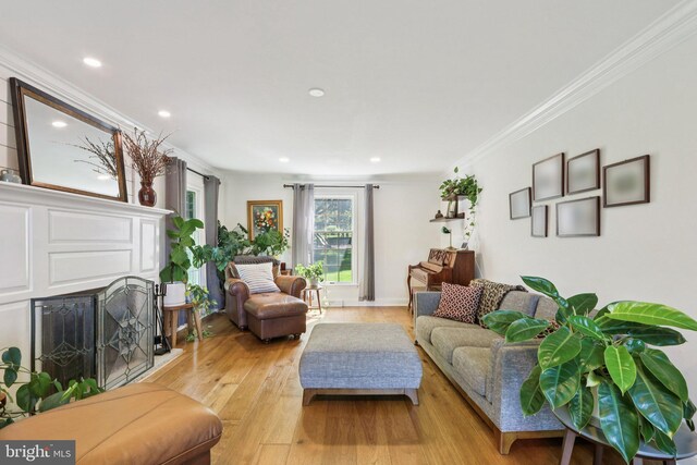 1118 Dorset Dr, West Chester, PA 19382 - living area featuring light wood-style floors, ornamental molding, a fireplace with raised hearth, and recessed lighting