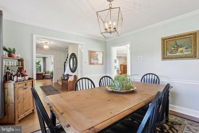 1118 Dorset Dr, West Chester, PA 19382 - dining space featuring light wood finished floors, crown molding, and a chandelier