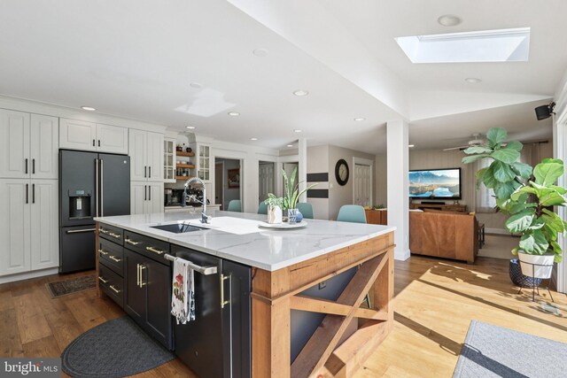 1118 Dorset Dr, West Chester, PA 19382 - kitchen with high quality fridge, white cabinetry, dark wood-style flooring, a skylight, and open shelves