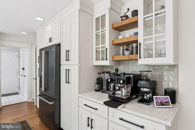 1118 Dorset Dr, West Chester, PA 19382 - kitchen featuring high end fridge, tasteful backsplash, white cabinetry, light wood-style flooring, and glass insert cabinets