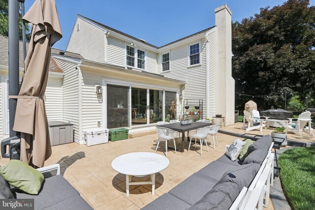 1118 Dorset Dr, West Chester, PA 19382 - back of property featuring a patio area, outdoor dining space, a chimney, and an outdoor hangout area