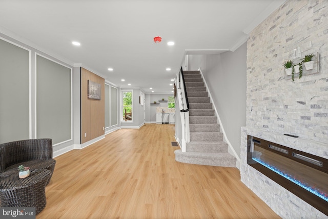 7632 Fayette St, Philadelphia, PA 19150 - unfurnished living room featuring crown molding, wood finished floors, stairway, recessed lighting, and a fireplace