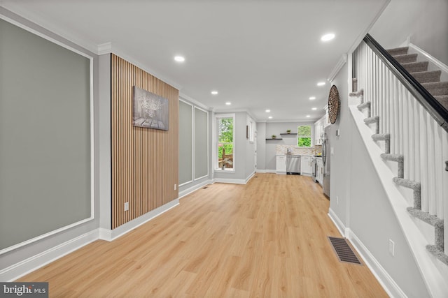 7632 Fayette St, Philadelphia, PA 19150 - unfurnished living room with ornamental molding, stairs, light wood-type flooring, and recessed lighting