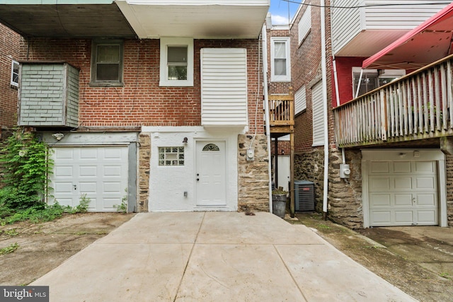 7632 Fayette St, Philadelphia, PA 19150 - view of front of property featuring a garage, stone siding, and concrete driveway