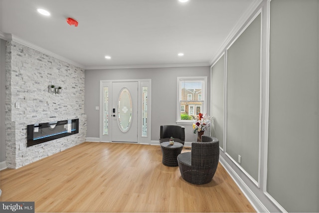 7632 Fayette St, Philadelphia, PA 19150 - entrance foyer with ornamental molding, a stone fireplace, wood finished floors, and recessed lighting