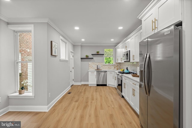 7632 Fayette St, Philadelphia, PA 19150 - kitchen with appliances with stainless steel finishes, open shelves, light wood-style flooring, white cabinetry, and light countertops