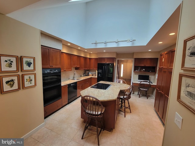7 E Cardiff Ct, Newark, DE 19711 - kitchen featuring black appliances, a kitchen bar, decorative backsplash, light stone counters, and recessed lighting