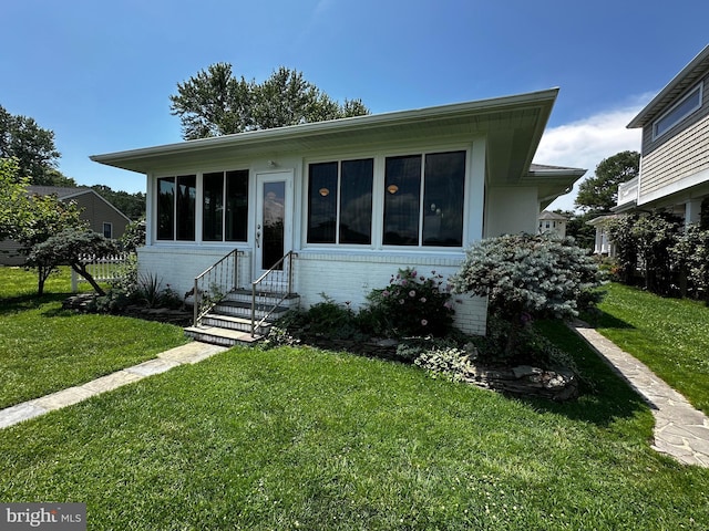 644 Chester River Beach Rd, Grasonville, MD 21638 - view of front of home with entry steps, a front lawn, and brick siding