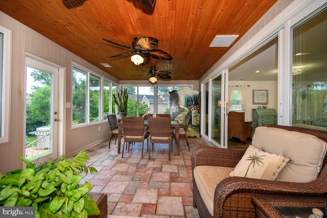 644 Chester River Beach Rd, Grasonville, MD 21638 - sunroom / solarium featuring outdoor dining area, stone tile flooring, wooden ceiling, and a ceiling fan