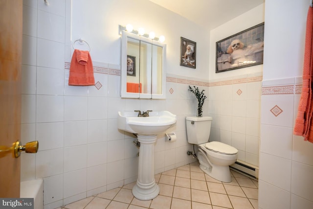 644 Chester River Beach Rd, Grasonville, MD 21638 - bathroom featuring a baseboard heating unit, wainscoting, tile patterned flooring, and tile walls