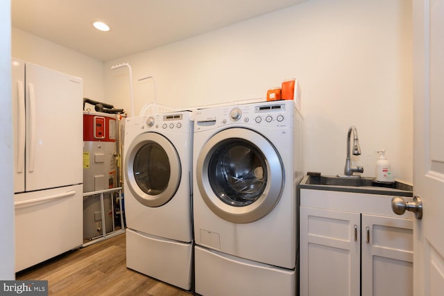 644 Chester River Beach Rd, Grasonville, MD 21638 - washroom featuring washing machine and dryer, cabinet space, light wood-style floors, and recessed lighting