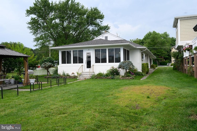 644 Chester River Beach Rd, Grasonville, MD 21638 - view of front facade with entry steps, a fenced backyard, a gazebo, and roof with shingles