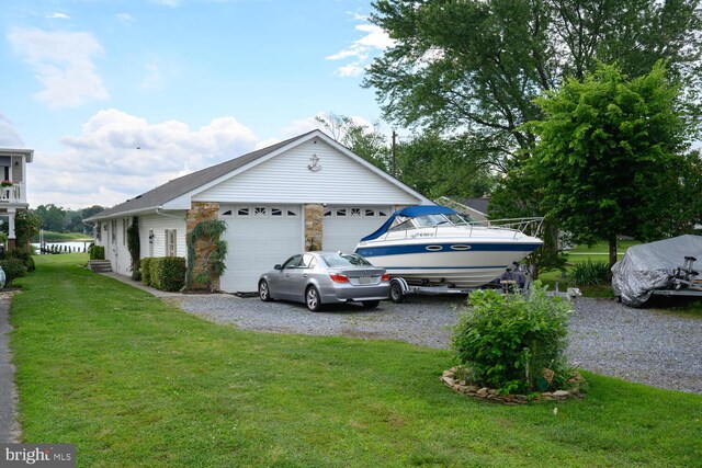 644 Chester River Beach Rd, Grasonville, MD 21638 - view of property exterior with a yard, a garage, and stone siding