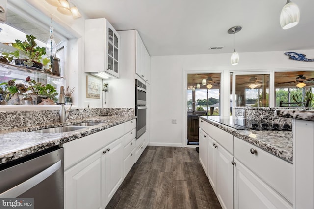 644 Chester River Beach Rd, Grasonville, MD 21638 - kitchen featuring stainless steel appliances, glass insert cabinets, light stone counters, and ceiling fan