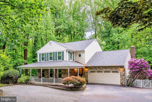 2930 Fox Mill Rd, Oak Hill, VA 20171 - view of front of property featuring asphalt driveway, stone siding, a porch, a chimney, and an attached garage