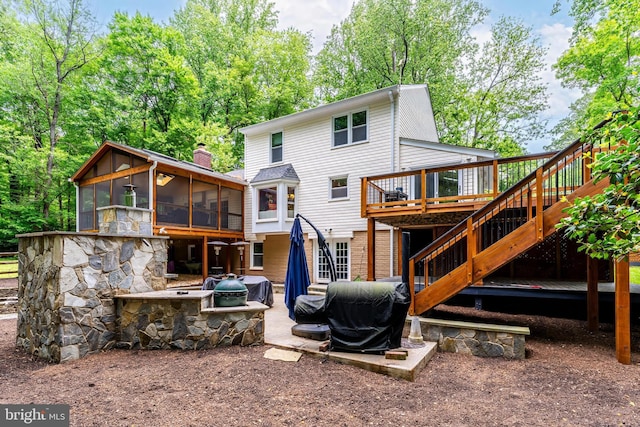 2930 Fox Mill Rd, Oak Hill, VA 20171 - back of property with a sunroom, stairway, a wooden deck, an outdoor fire pit, and a patio area