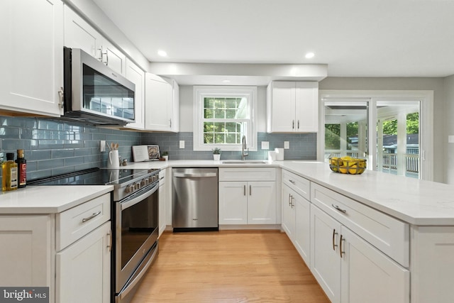 6 Ivywood Ct, Silver Spring, MD 20904 - kitchen with stainless steel appliances, a peninsula, tasteful backsplash, white cabinets, and recessed lighting