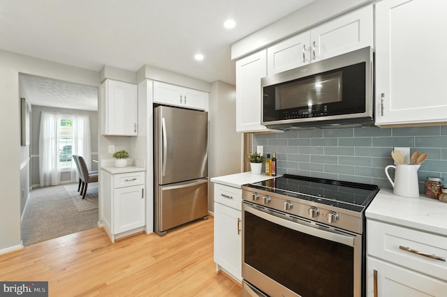 6 Ivywood Ct, Silver Spring, MD 20904 - kitchen featuring appliances with stainless steel finishes, light wood-style floors, white cabinetry, backsplash, and recessed lighting