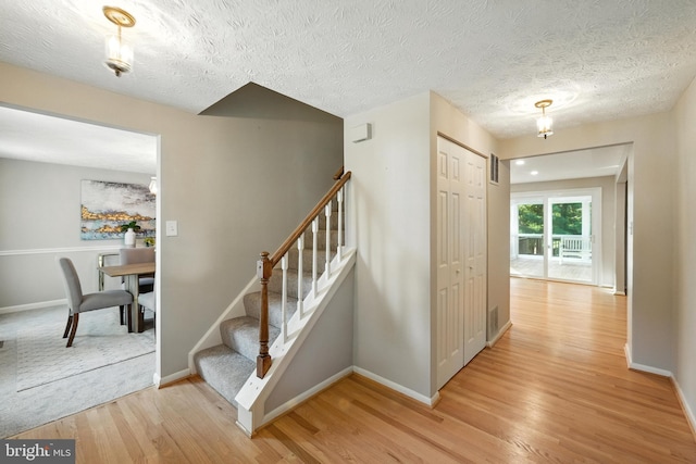 6 Ivywood Ct, Silver Spring, MD 20904 - stairway with wood finished floors and a textured ceiling