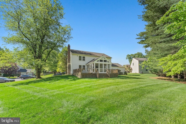 6 Ivywood Ct, Silver Spring, MD 20904 - rear view of property featuring a chimney, a sunroom, a wooden deck, and a lawn